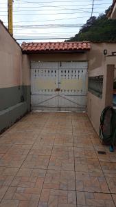 une paire de portes de garage sur une maison dans l'établissement Kazapraia, à Mongaguá
