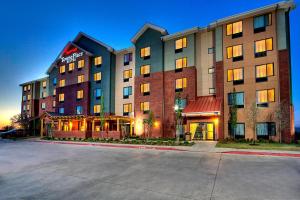 a large building with a restaurant in front of it at TownePlace Suites Oklahoma City Airport in Oklahoma City