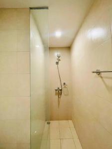 baño con ducha y puerta de cristal en * *7 Metro View Studio, en Iloilo City