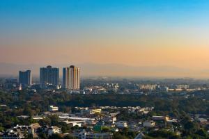 a cityscape of a city at sunset with buildings at Chiang Mai Marriott Hotel in Chiang Mai