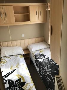 two beds are in a small room at Southview cedar bank 6 in Skegness