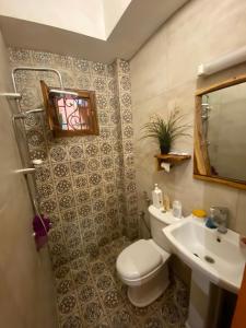 a bathroom with a toilet and a sink at Keur Marieme in Dakar