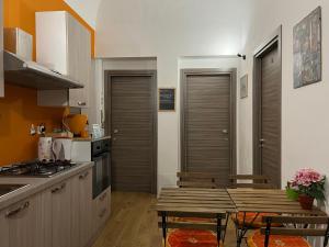 a kitchen with a table and a kitchen with a stove at Ricasoli28 Apartaments in Palermo