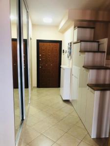 cocina con pasillo con nevera y puerta en Lakeview Cozy Apartment, en Pogradec