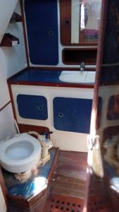 a small bathroom with a toilet and a sink at Joli voilier de 13m in Les Trois-Îlets