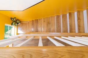 an empty church with yellow walls and wooden benches at Tròn Beach Villa- NovaWorld Phan Thiet in Phan Thiet +78 photos