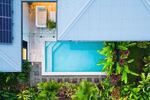 an overhead view of a swimming pool in a house at Flagship Villa in Trinity Beach