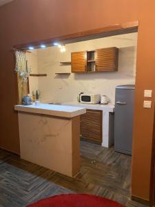 a kitchen with a sink and a refrigerator at Keur royal in Dakar