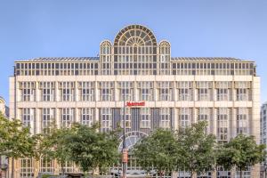 a large tan building with a red sign on it at Vienna Marriott Hotel in Vienna