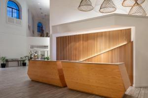 a lobby with a wooden reception desk with at Grand Cayman Marriott Resort in George Town