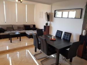 a living room with a black table and chairs at Apartments with a parking space Umag - 22348 in Umag