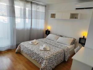 a bedroom with a bed with two towels on it at Apartments with a parking space Umag - 22348 in Umag