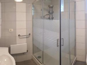 a bathroom with a glass shower with a toilet at Apartments with a parking space Umag - 22348 in Umag +6 photos