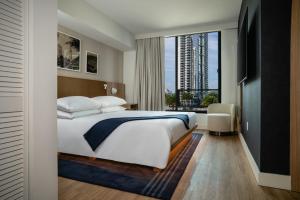 a hotel room with a bed and a large window at Gale Miami Hotel & Residences in Miami