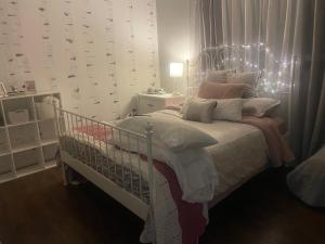a bedroom with a bed with a crib at Zen Queen Room in West Kelowna