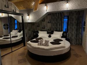 a bedroom with two large beds in a room at Heaven Apartment in Predeal
