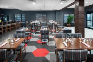 a dining room with wooden tables and chairs at Four Points by Sheraton Oklahoma City Airport in Oklahoma City