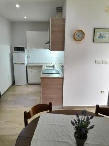 - une cuisine avec une table et un comptoir dans l'établissement Apartments with a parking space Njivice, Krk - 22769, à Njivice
