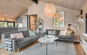 a living room with a couch and a table at Three-Bedroom Holiday Home In Jerup in Jerup