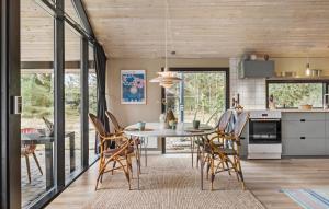 a kitchen and dining room with a table and chairs at Three-Bedroom Holiday Home In Jerup in Jerup