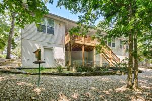 a house with a deck and a porch at Relaxing BV Home near Golfing, Hiking, & Lakes in Bella Vista