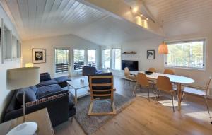 a living room with a couch and a table at Gorgeous Home In Jrpeland With House Sea View in Jørpeland