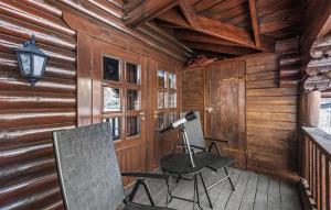 a room with two chairs and a desk and a lamp at Nice Home In Vrådal With Kitchen in Vradal