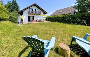 due sedie blu sedute sull'erba di fronte a una casa di Ferienhaus 31 In Kirchheim a Kemmerode Altre 18 foto