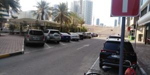 a row of cars parked on the side of a street at قصر الماسه in Sharjah