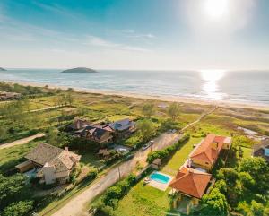 an aerial view of a house next to the ocean at Kahuma in Imbituba