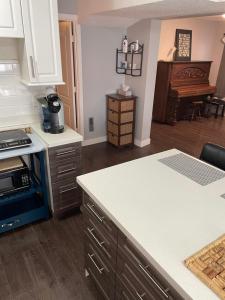 a kitchen with a counter top and a stove top oven at Suite Sunrise in Vancouver