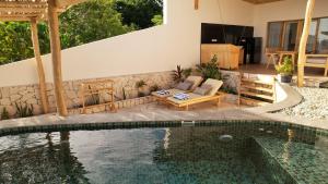 a swimming pool in a backyard with a house at Akasha Beach Club in Bulukumba