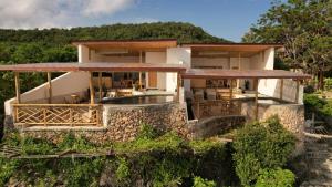 an aerial view of a house with a stone wall at Akasha Beach Club in Bulukumba