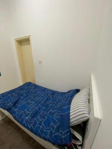 a bed with a blue comforter in a room at قصر الماسه in Sharjah