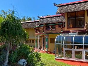 a house with a glass greenhouse in front of it at Maui Eco Retreat in Huelo