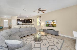 a living room with a couch and a table at Elegant Lennar Free Water Park Resort in Kissimmee