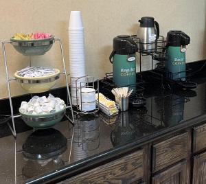 a counter with two coffee makers and a bowl of food at Red Roof Inn Dunn in Dunn