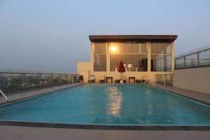 a swimming pool on the roof of a building at Luxury Ocean Condos by Travel Bee in Negombo