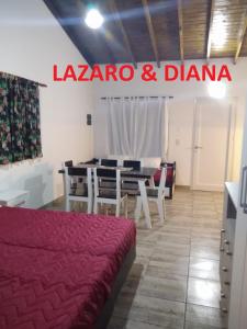a room with a table and chairs and a sign at Lázaro & Diana in San Clemente del Tuyú +17 photos