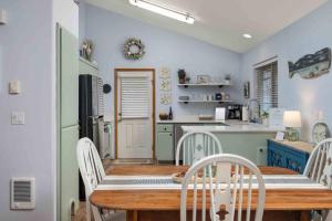 a kitchen with a table and chairs in a room at Beach Bungalow in Rockaway Beach +25 photos