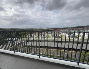 a balcony with a view of a river and buildings at Happy House in Sandakan