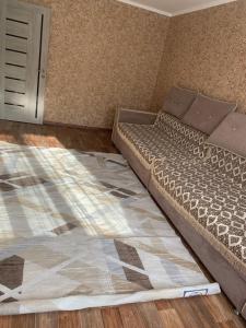 a small bedroom with a bed in a room at трёхкомнатная после ремонта с удобным расположением in Karagandy