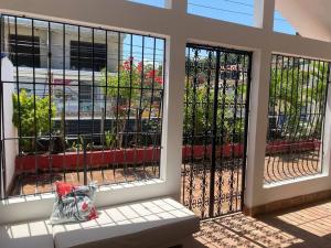 a bench sitting in front of a building with gates at Alojamiento Samanà in Santa Bárbara de Samaná