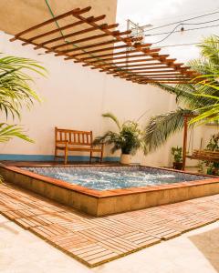 a pool in the middle of a patio with a bench at Room in Guest room - Hb8 Quadruple Room with shared bathroom in Cartagena de Indias