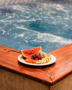 a plate of food on a table next to a pool at Room in Guest room - Hb8 Quadruple Room with shared bathroom in Cartagena de Indias