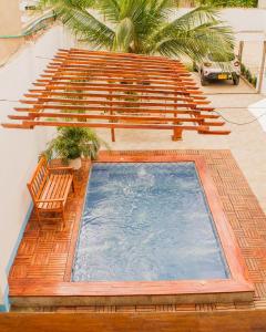 a swimming pool with a bench and a bench at Room in Guest room - Hb8 Quadruple Room with shared bathroom in Cartagena de Indias