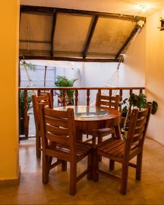 a wooden table and chairs in a room with a balcony at Room in Guest room - Hb8 Quadruple Room with shared bathroom in Cartagena de Indias