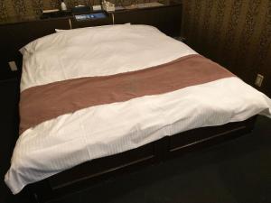 Postel nebo postele na pokoji v ubytování グッドホテル大阪 大人専用