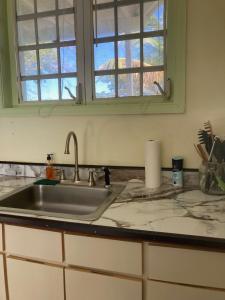a kitchen counter with a sink and a window at Boundless Bliss Hotel in St Thomas