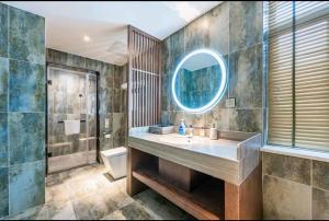 a bathroom with a sink and a mirror at Mehood Theater Hotel, Zhonglou Metro Station Huimin Street in Xi'an